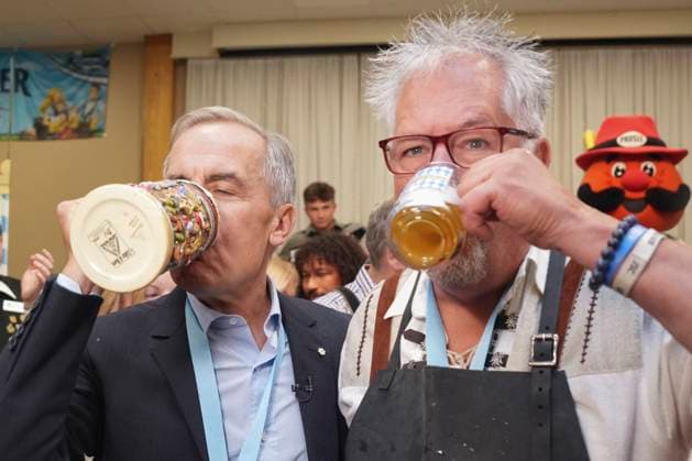 October 17, 2025, Breslau, On, Canada: Prime Minister Mark Carney takes a sip of beer with Darryl Fletcher, President of the Board of Oktoberfest after tapping a keg at an Oktoberfest event at the Schwaben Club in Breslau, Ont., on Friday, Oct. 17, 2025. Breslau Canada  - ZUMAc35_ 20251017_zaf_c35_037 Copyright: xChrisxYoungx