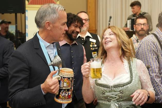 October 17, 2025, Breslau, On, Canada: Prime Minister Mark Carney, left, shares a joke with with Tracy Van Kalsbeek, Executive Director of the Board of Oktoberfest, at an Oktoberfest event, at the Schwaben Club in Breslau, Ont., on Friday, Oct. 17, 2025. Breslau Canada - ZUMAc35_ 20251017_zaf_c35_048 Copyright: xChrisxYoungx