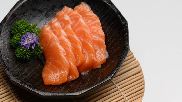 Delicious sashimi salmon arranged on a black stone plate with parsley leave Delicious sashimi salmon arranged on a black stone plate with parsley leave., 59449586.jpg RECORD DATE NOT STATED