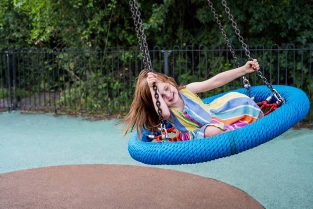 Smiling little girl at playground. Toddler child having fun at a swing Corby, England, United Kingdom R_ATMT250629C-1773386-01 ,model released, Symbolfoto