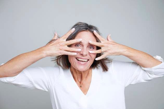 Smiling woman with gray hair posing playfully in studio model released, Symbolfoto property released, JBYF00300