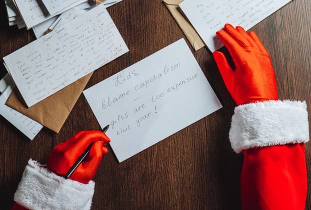 Santa Claus writing a humorous letter about expensive gifts and capitalism model released, Symbolfoto, AAF00253