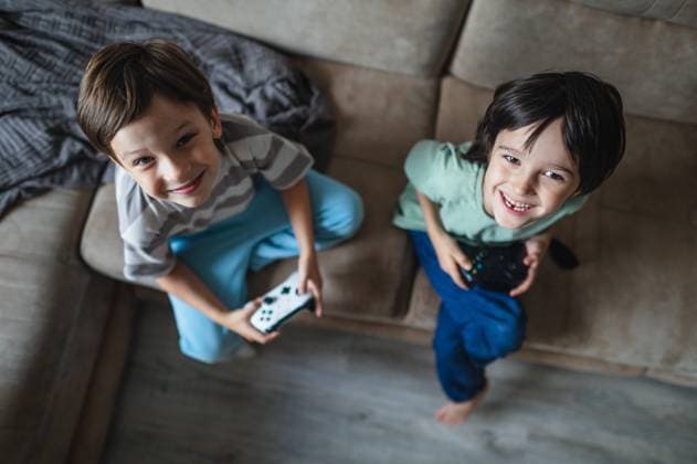 Smiling children playing video games with console at home model released, Symbolfoto property released, ANAF05187