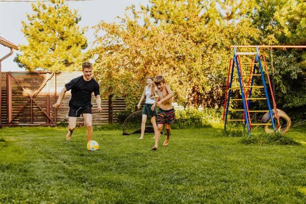 Teens and kids playing football together in a sunny back yard model released, Symbolfoto property released, MDOF03159