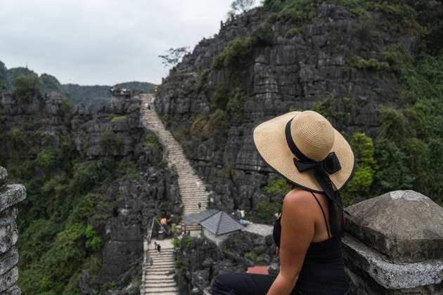 Tourist with hat overlooking green mountains at Ninh Vinh Vietnam model released, Symbolfoto property released, PNAF06762