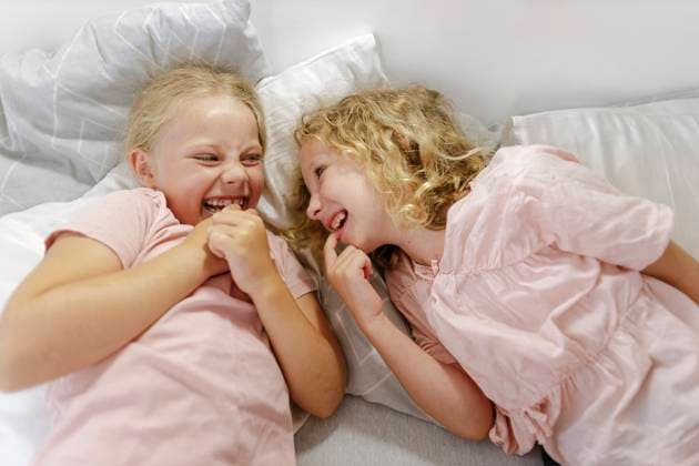 Two girls laughing and bonding together in bed at home model released, Symbolfoto property released, SIF01406