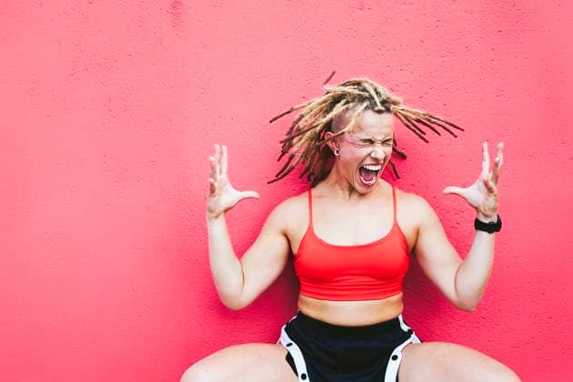 Athletic woman with dreadlocks screaming in red sport outfit outdoors model released, Symbolfoto, SVCF00518