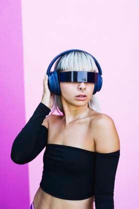 Futuristic woman with visor glasses and headphones on pink background model released, Symbolfoto, SVCF00535