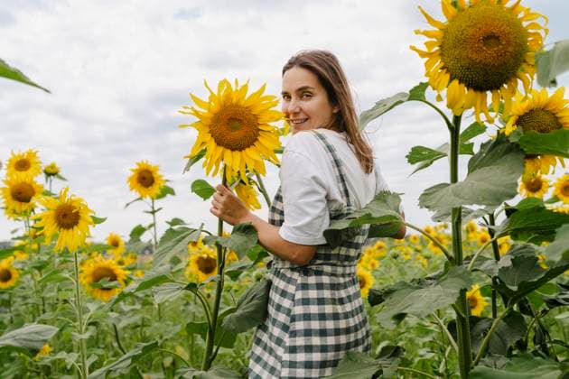 Happy woman in sunflower field smiling and enjoying nature model released, Symbolfoto, VBUF00716