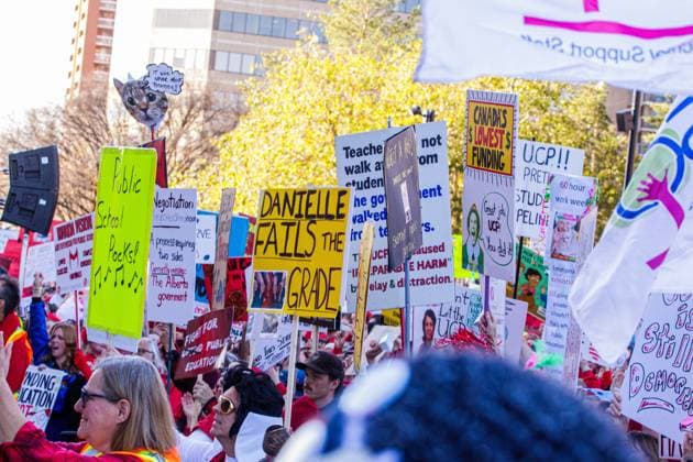 October 23, 2025, Edmonton, Alberta, Canada: Protesters hold placards expressing their opinion during the demonstration. Over 20,000 people with various signs speaking out about the state of education under the current Premier Danielle Smith, rallied outside the Alberta Legislature as the Throne Speech was being read in the legislature. Teachers have been on strike since October 7th and have rejected 2 offers from the Province. The Main Issues are Class Sizes, Educational Assistant Support, and wages. Teachers made an offer to the province, which has not been responded to. The Province is expected to introduce back to work legislation Monday. Edmonton Canada - ZUMAs197 20251023_aaa_s197_343 Copyright: xRonxPalmerx