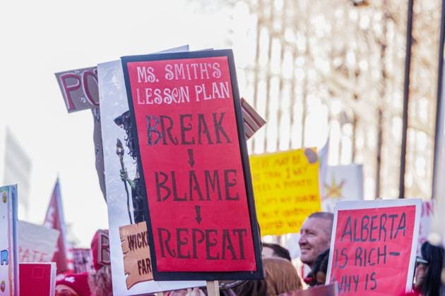 October 23, 2025, Edmonton, Alberta, Canada: Protesters hold placards expressing their opinion during the demonstration. Over 20,000 people with various signs speaking out about the state of education under the current Premier Danielle Smith, rallied outside the Alberta Legislature as the Throne Speech was being read in the legislature. Teachers have been on strike since October 7th and have rejected 2 offers from the Province. The Main Issues are Class Sizes, Educational Assistant Support, and wages. Teachers made an offer to the province, which has not been responded to. The Province is expected to introduce back to work legislation Monday. Edmonton Canada - ZUMAs197 20251023_aaa_s197_356 Copyright: xRonxPalmerx