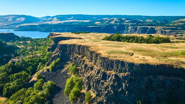 Aerial View of Columbia Gorge River and Cliffs at Rowena Crest Stunning aerial view of Columbia River Gorge from Rowena Crest Viewpoint in Mosier, Oregon. The dramatic cliffs and lush valleys showcase the majestic beauty of this iconic natural wonder. Ideal for travel and nature themes., 60920848.jpg RECORD DATE NOT STATED