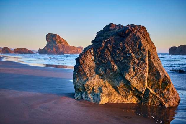 Rugged Rock Formation at Golden Hour on Meyers Creek Beach Ocean View Golden hour at Meyers Creek Beach, Oregon captures the rugged beauty of two large rocks on a tranquil sandy shore. Soft lighting enhances the serene coastal landscape, perfect for nature and travel enthusiasts., 60684968.jpg RECORD DATE NOT STATED