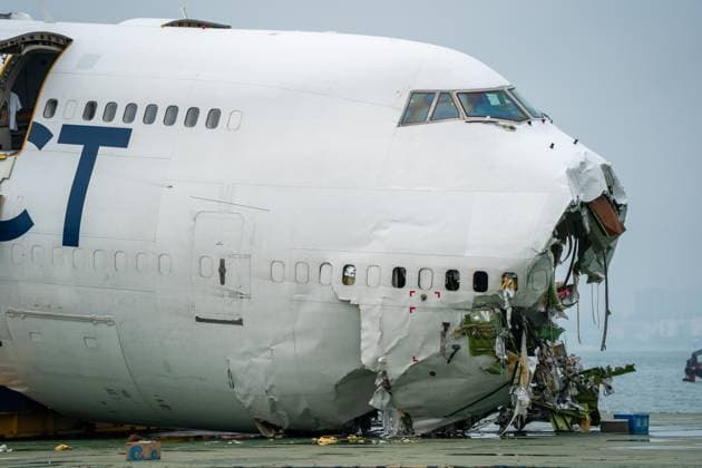 Hong Kong Plane Accident Wreckage The main fuselage section of an ACT Airlines Boeing 747-400 cargo aircraft which skidded off the runway while landing on at Hong Kong International Airport on a flat deck barge on October 28, 2025 in Hong Kong. The Boeing 747 skidded off the runway while landing at Hong Kong International Airport killing two on the ground in a security guard vehicle. (Photo by Vernon Yuen Nexpher Images) Hong Kong