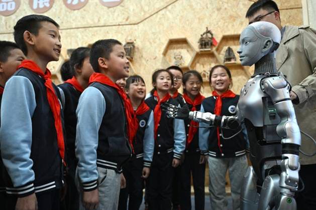HEFEI, CHINA - OCTOBER 27: Students from the Primary School Affiliated to Hefei Normal School listen to a humanoid robot Xiao An, during a science class on October 27, 2025 in Hefei, Anhui Province of China. On October 27, the science class at the Primary School Affiliated to Hefei Normal School was delivered by Xiao An, a 1.4-meter-tall humanoid robot serving as a teaching assistant.  Copyright: xChinaxNewsxServicex 111600014838
