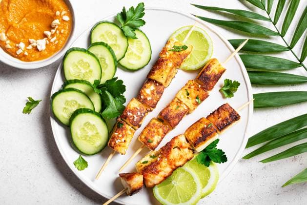 Gegrillte Tofu-Satay-Spieße und scharfe Erdnuss-Sauce Grilled tofu satay skewers and peanut spicy sauce on white plate close up.. Asian vegan vegetarian lunch, thai style food. (License=RF) Copyright: xZoonar.com OksanaxBratanovax 24138449
