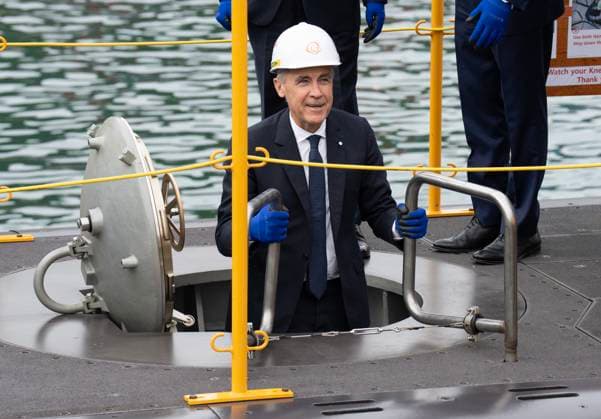October 30, 2025, Geoje Island, South Korea: Prime Minister Mark Carney smiles as he climbs down a ladder into a submarine during a tour of the Hanwha Ocean Shipyard in Geoje Island, South Korea, Thursday Oct. 30, 2025. Geoje Island South Korea  - ZUMAc35_ 20251030_zaf_c35_006 Copyright: xAdrianxWyldx