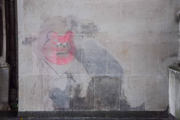 October 31, 2025, London, England, United Kingdom: Graffiti has appeared on the artwork by elusive street artist Banksy at the Royal Courts of Justice, depicting a judge hitting a protester with a gavel, which has been partially cleaned off after the court ordered it to be removed. London United Kingdom - ZUMAv130 20251031_zip_v130_012 Copyright: xVukxValcicx