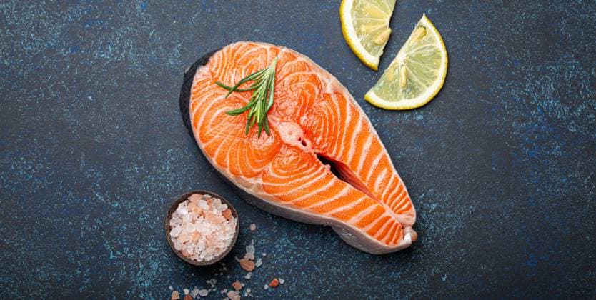 Fresh raw salmon fillet steak with rosemary on dark blue rustic stone background with rose salt and lemon top view, healthy balanced diet and nutrition Fresh raw salmon fillet steak with rosemary on dark blue rustic stone background with rose salt and lemon top view, healthy balanced diet and nutrition with fish, 61282368.jpg RECORD DATE NOT STATED