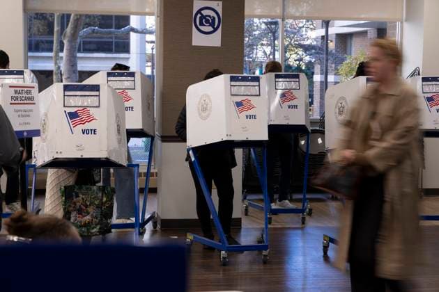 November 4, 2025, New York, New York, USA: Voters in lower Manhattan cast their ballots in privacy booths printed with an image of an American Flag and VOTE at their polling site on Election Day. The Mayoral election in New York City is a highly watched race between Mamdani, Cuomo and Sliwa. New York USA - ZUMAr174 20251104_znp_r174_027 Copyright: xGinaxMxRandazzox