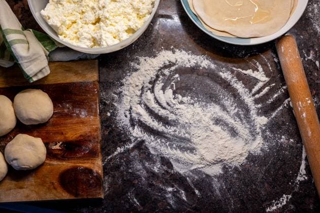 Cooking cottage cheese pie, dough balls on table Corby, England, United Kingdom R_ATMT250507A-1720117-01