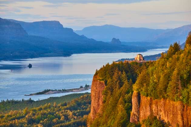 Aerial Fly Over Vista House Columbia River Gorge Golden Hour Golden hour at Columbia River Gorge with the historic Vista House at Crown Point. Lush forests and the meandering river create a serene landscape, showcasing Oregon s natural beauty. Ideal for travel and nature themes., 60924276.jpg RECORD DATE NOT STATED