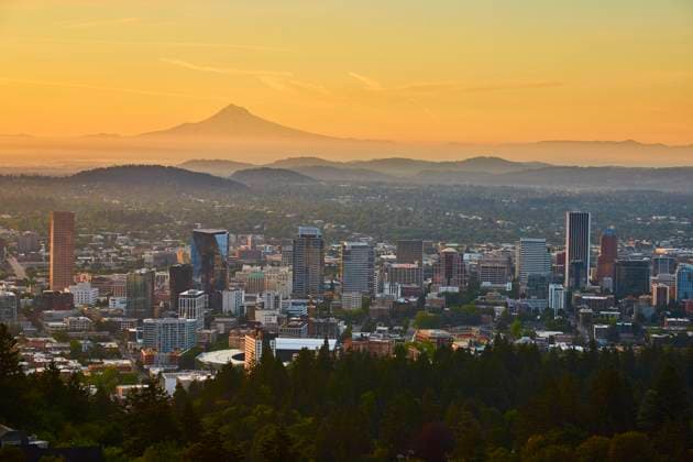 Aerial View of Portland Skyline with Mount Hood at Sunrise Experience the serene beauty of a Portland sunrise as the cityscape and iconic Mount Hood create a stunning backdrop. Perfect for travel, real estate, and nature-inspired projects. Portland, Oregon, USA., 60924326.jpg RECORD DATE NOT STATED