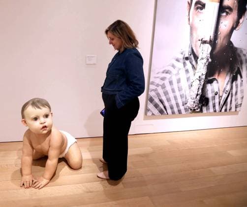 November 6, 2025, New York, New York, USA: A woman seen with Big Baby 3 by artist Ron Mueck, estimate $700,000 - $1 million seen during the press preview for ChristieÃ¢â‚¬â ¢s 20-21 Marquee Week Fall 2025 Evening Sale Highlights held at ChristieÃ¢â‚¬â ¢s New York Rockefeller Center. New York USA - ZUMAk03_ 20251106_zaf_k03_020 Copyright: xNancyxKaszermanx