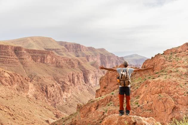 MR_ID31114_23071_YolandaPoma.jpg, MR_ID31114_22459_PauCardellach.jpg A solo traveler embraces the vast beauty of Dades Gorges canyon in the Atlas Mountains of Morocco. The stunning landscape highlights the allure of African outdoor adventures. Model Released Cardellach_ID31114_1055586_007 Copyright: xCardellachx RECORD DATE NOT STATED