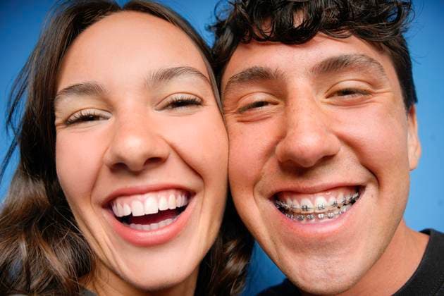 Young friends laughing against blue background Two young friends share a joyful moment, laughing warmly in front of a vibrant blue background, showcasing happiness, friendship, and youthful spirit with wide smiles. Model Released DondykRiga_ID32151_1094775_003 Copyright: xDondykxRigax RECORD DATE NOT STATED