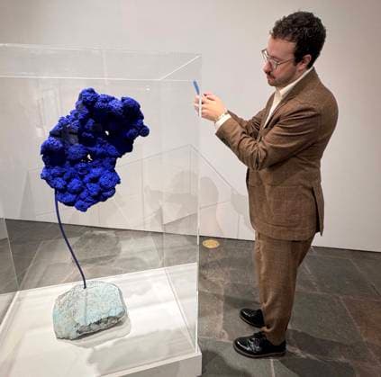 November 7, 2025, New York, New York, USA: A man takes a cellphone photo of Sculpture eponge bleue sans titre (SE 167), circa 1959, by artist Yves Klein, estimate $14 million - $18 million, seen on display during November Marquee Week 2025 during SothebyÃ¢â‚¬â ¢s Opening of the New Global Headquarters at the Breuer. New York USA - ZUMAk03_ 20251107_zaf_k03_118 Copyright: xNancyxKaszermanx