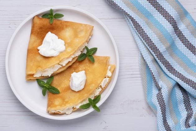 Thin pancakes, russian blini or french crepes with cottage cheese. Tasty homemade breakfast. Top view, copy space Thin pancakes, russian blini or french crepes with cottage cheese. Tasty homemade breakfast. Top view, copy space., 62988116.jpg RECORD DATE NOT STATED