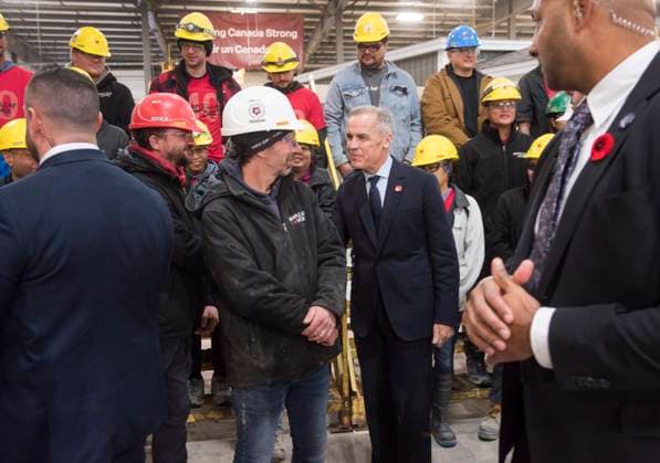 November 10, 2025, Fredericton, Nb, Canada: Prime Minister Mark Carney center, talks with workers after making an announcement at the manufacturing facility of Maple Leaf Homes in Fredericton, N.B., on Monday, Nov. 10, 2025. Fredericton Canada  - ZUMAc35_ 20251110_zaf_c35_038 Copyright: xStephenxMacgillivrayx