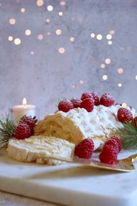 Christmas Buche de Noel White Yule Log Cake with Bokeh Lights on White Marble Board. Christmas Buche de Noel White Yule Log Cake with Bokeh Lights on White Marble Board. Copyright: xMilleflorexImagesx MIL091025-1