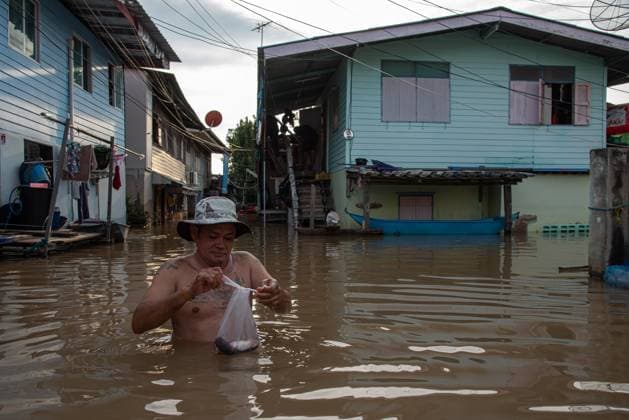 Floodwaters in Ayutthaya, Thailand - 11 Nov 2025 A man stands in floodwaters from the Chao Phraya River in front of his village at Ayutthaya. Ayutthaya flood was caused by heavy rainfall from tropical storms, which led to an increased discharge of water from the Chao Phraya Dam, overwhelming riverbanks in low-lying areas of the province. Ayutthaya Thailand Copyright: xPeeraponxBoonyakiatx xSOPAxImagesx FloodAyutthaya-12