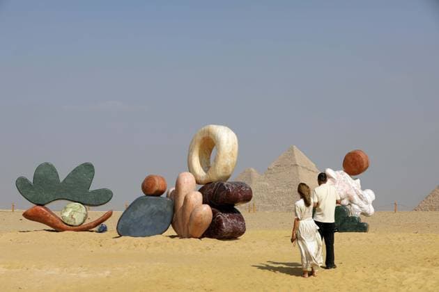 (251111) -- CAIRO, Nov. 11, 2025 -- Visitors view an artwork exhibited during the Forever Is Now international art exhibition at Giza Pyramids scenic spot in Giza, Egypt, Nov. 11, 2025. The fifth edition of Forever Is Now international art exhibition on Tuesday kicked off in the area of Egypt s Giza Pyramids scenic spot, showcasing 10 artworks of artists from different countries. The exhibition runs from Nov. 11 to Dec. 6. Ahmed Gomaa) EGYPT-GIZA-PYRAMIDS-ART EXHIBITION-FOREVER IS NOW AixHamaide¡¤gema 