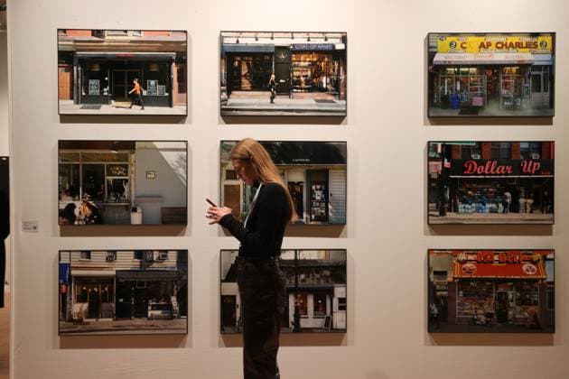 A visitor to the 2025 Paris Photo Fair stands in front of photographs by Martha Rosler on display at the Nager Draxter Gallery on the opening day at the Grand Palais, on Wednesday, November 12, 2025. The world s most important international photography fair brings together iconic and emerging names, showcasing 179 galleries from 33 countries and a rich programme that encompasses photography in all its forms, from silver gelatin to blockchain.  PAR20251112117 MAYAxVIDON-WHITE