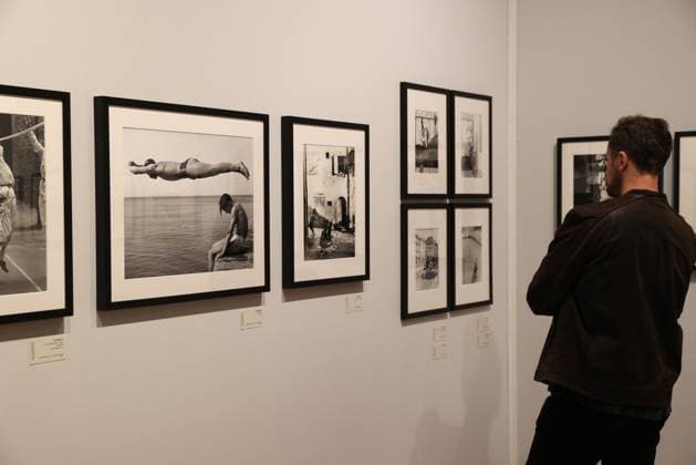 A visitor to the 2025 Paris Photo Fair looks at photographs by Nino Migliori on display at the Admira Gallery stand, on the opening day at the Grand Palais, on Wednesday, November 12, 2025. The world s most important international photography fair brings together iconic and emerging names, showcasing 179 galleries from 33 countries and a rich programme that encompasses photography in all its forms, from silver gelatin to blockchain.  PAR20251112120 MAYAxVIDON-WHITE
