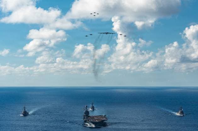 The U.S. Navy s Gerald R. Ford Carrier Strike Group, including the flagship USS Gerald R. Ford (CVN 78), front, USS Winston S. Churchill (DDG 81), right, USS Mahan (DDG 72), left, USS Bainbridge (DDG 96), and embarked Carrier Air Wing Eight F A-18E F Super Hornets assigned to Strike Fighter Squadrons 31, 37, 87, and 213, operates as a joint, multi-domain force with a U.S. Air Force B-52 Stratofortress, on Thursday, November 13, 2025. U.S. military forces, like the Gerald R. Ford Carrier Strike Group, are deployed in support of the U.S. Southern Command mission, Department of War-directed operations, and the President s priorities to disrupt illicit drug trafficking and protect the homeland.  WAX2025111410 PO3xGLADJIMIxBALISAGE
