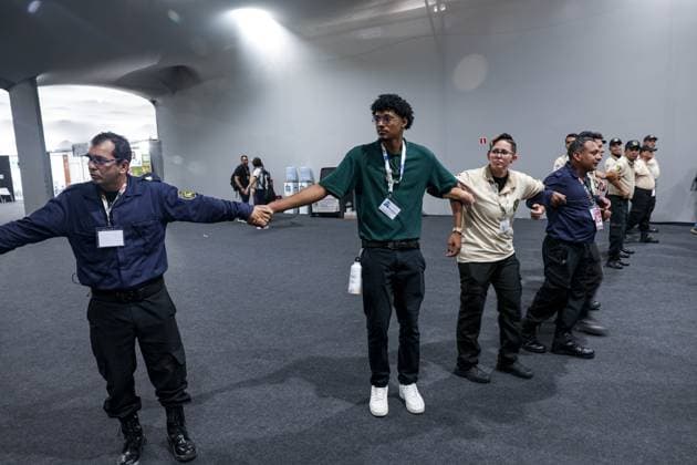 November 20, 2025, Belem, Brazil, Brazil: Security personnel form a cordon inside the COP30 venue during the evacuation following a fire in the pavilion section in Belem, Brazil. The incident prompted attendees to leave the area as emergency teams responded. Belem Brazil - ZUMAo116 20251120_znp_o116_082 Copyright: xBiancaxOterox