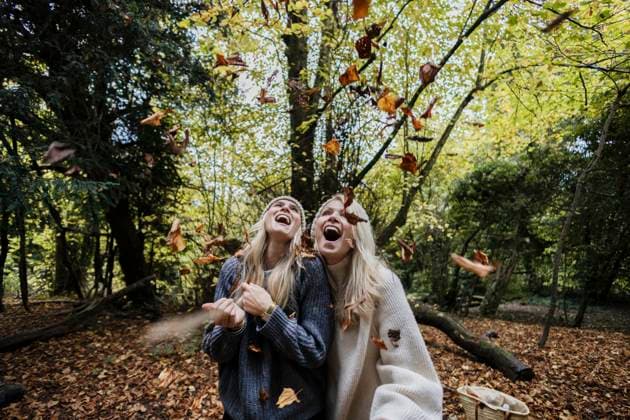 Laughing friends enjoying autumn leaves together in the forest model released, Symbolfoto, ASGF07233