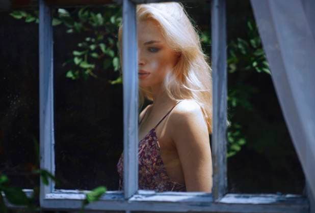 Woman with blond hair standing behind window in atmospheric mood model released, Symbolfoto, AZF00968