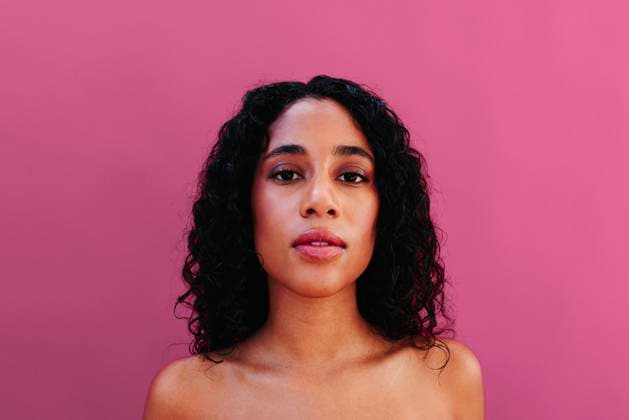 Portrait with curly hair and natural beauty on pink background model released, Symbolfoto, FOMF00552