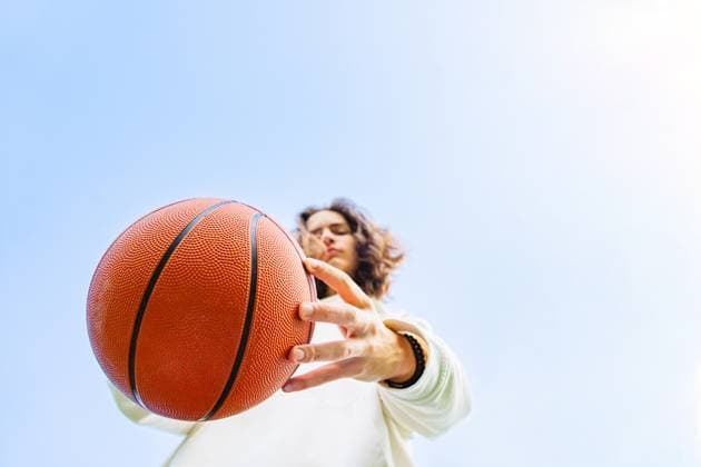Teenager holding basketball outdoors with confidence and energy model released, Symbolfoto, IHF02528