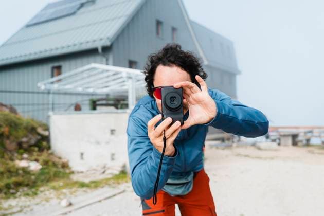 Person taking photograph outdoors during trekking in mountains model released, Symbolfoto, NDEF02937