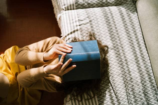 Woman relaxing at home with book on face enjoying leisure time model released, Symbolfoto property released, NDEF02985