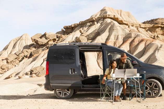 Digital nomads working with laptop and phone outdoors in Bardenas Reales model released, Symbolfoto, PCLF02911