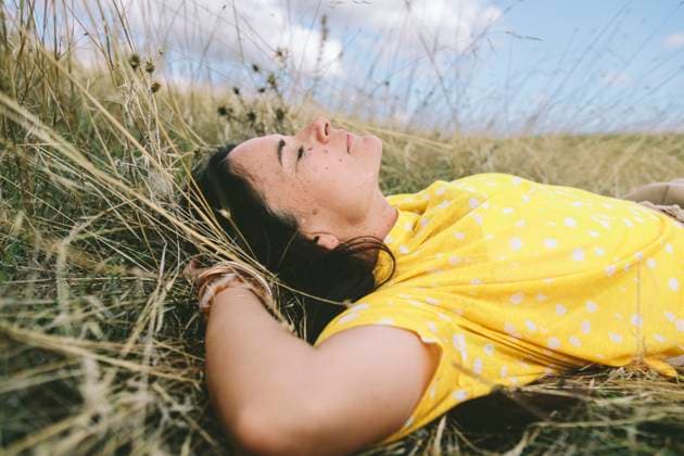 Resting woman in tall grass in nature practicing mindfulness and calm model released, Symbolfoto, SIF01441