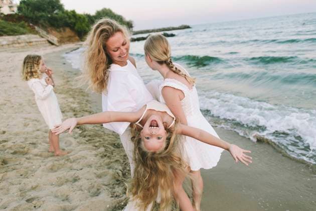 Family playing joyfully on the beach showing playfulness and bonding model released, Symbolfoto, SIF01483