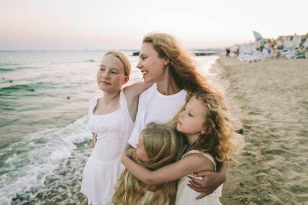 Family bonding and embracing together at the beach during summer model released, Symbolfoto, SIF01486